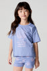 Front view of a girl wearing the Chaser Seashell Dreams Tee and shorts on a neutral background