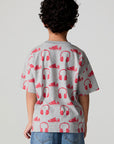 Back view of a boy wearing the Chaser Sneaks and Headphones Tee on a neutral background