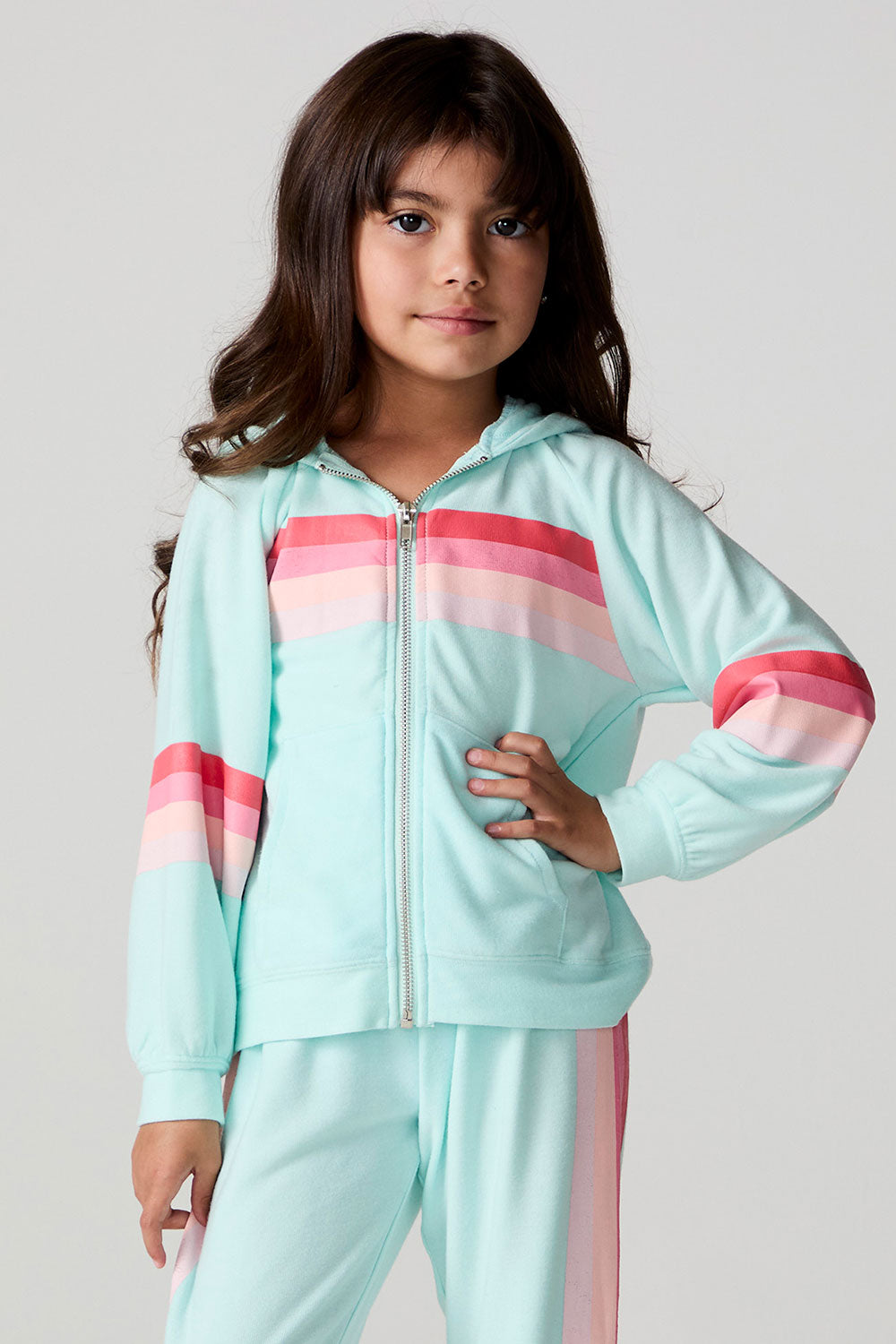 Full body front view of a girl wearing the Chaser Stripes for Days Hoodie on a neutral background holding a camera