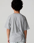 Back view of a boy wearing the Chaser Tennis Club Tee on a neutral background