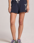 Front view of a woman wearing the Chaser Tie Dye Star Shorts on a neutral background
