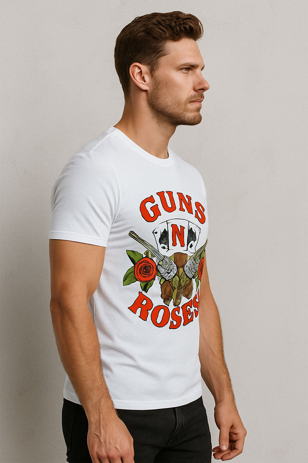 Man wearing a white t-shirt with 'Guns N' Roses' graphic design on a plain background