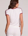 Back view of a woman wearing the Chaser Urban Cloud White Tee and pants on a neutral background