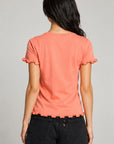 Back view of women’s coral Grateful Dead graphic tee with lettuce-edge ruffle sleeves and hem, styled with black denim shorts