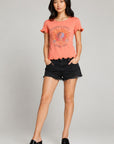 Women’s coral Grateful Dead 1977 Spring Tour graphic tee with lettuce-edge ruffle sleeves and hem, paired with black denim shorts and platform sandals