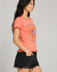 Side profile of women’s coral Grateful Dead 1977 Spring Tour graphic tee highlighting lettuce-edge ruffle sleeve detail and fitted silhouette