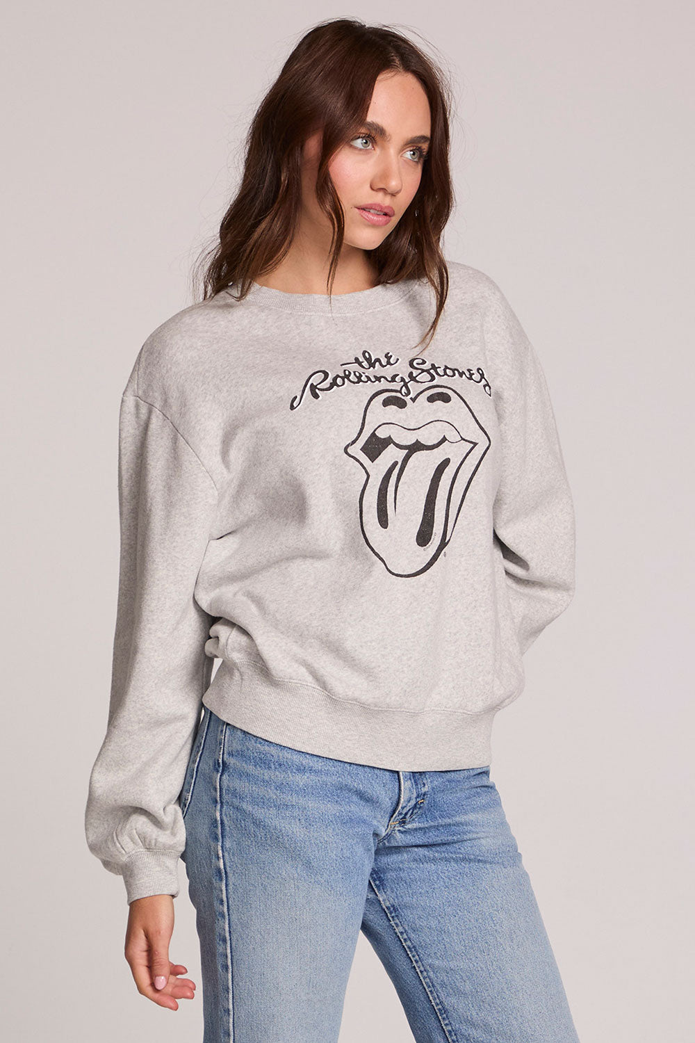 Front view of a woman wearing the Chaser The Rolling Stones Long Sleeve Tee on a neutral background with hand on one hip
